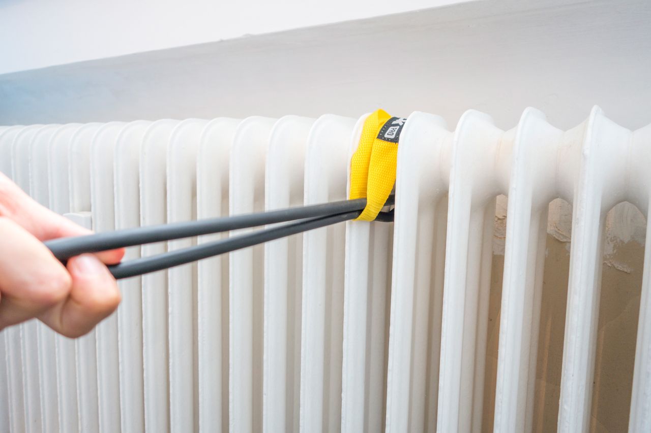 The yellow FEROK PRO loop wrapped around a radiator with the two cords pulled out of it